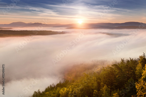 Great view of the foggy valley with sunrise. South Ural mountain