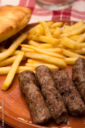 French fries with kebabs and bread bun  served