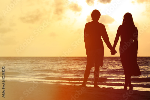 romantic couple holding hands at sunset © nadezhda1906