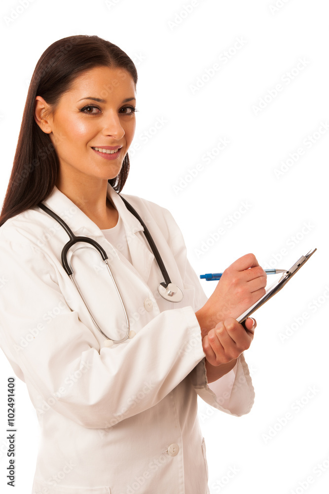 Woman doctor with stethoscope around neck writing diagnose on cl Woman doctor with stethoscope around neck writing diagnose on cl