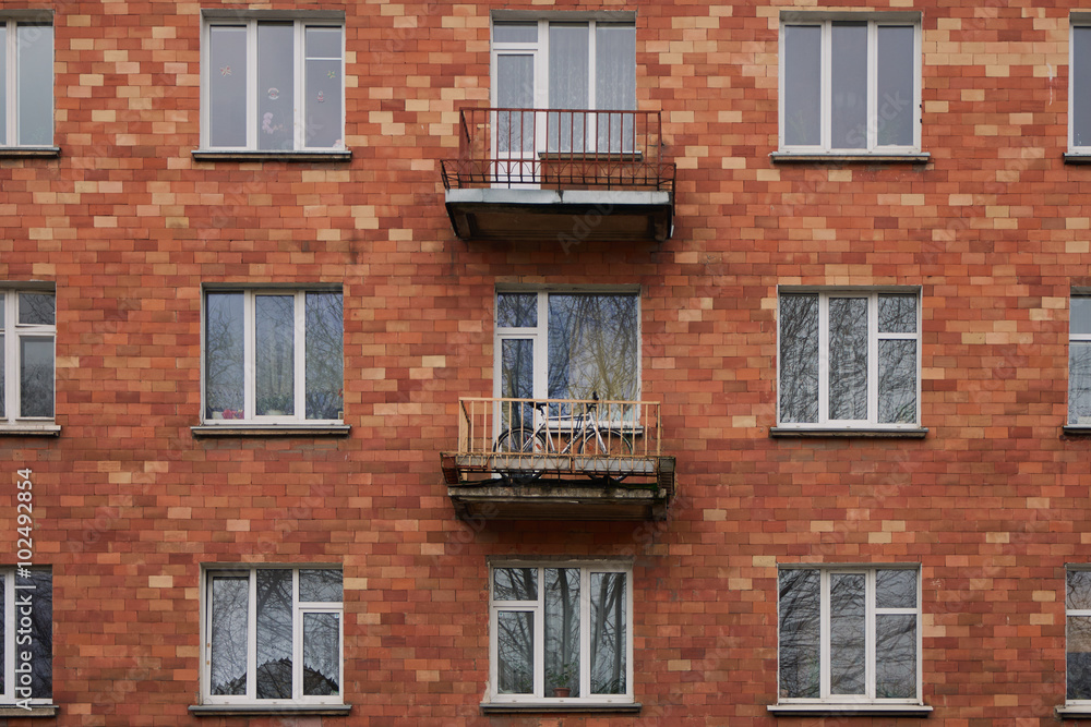 Red brick facade with windows and balconies in Vilnius