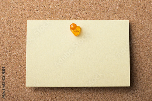 Blank adhesive label pinned on bulletin board