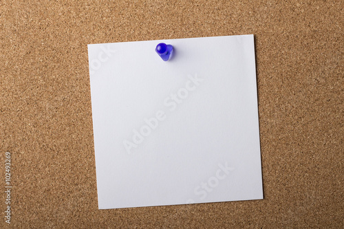 Blank adhesive label pinned on bulletin board