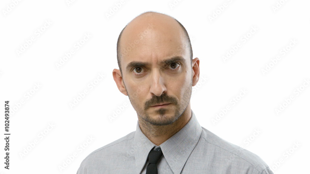 Young adult man looks at camera serious with a tough expression in the face Young adult man looks at camera serious with a tough expression in the face
