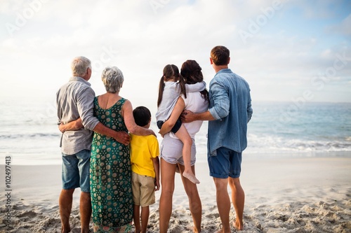 Cute family facing the sea