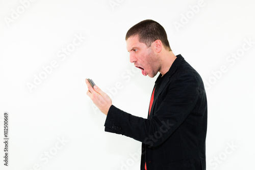 Caucasian angry business man screaming on mobile phone