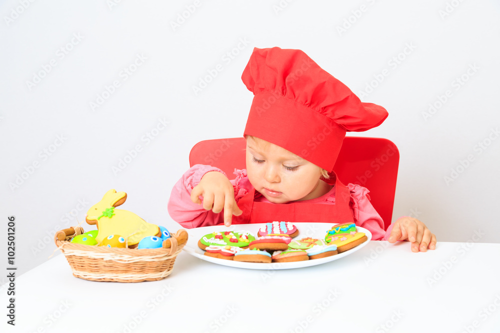 cute little girl playing with easter cookies cute little girl playing with easter cookies