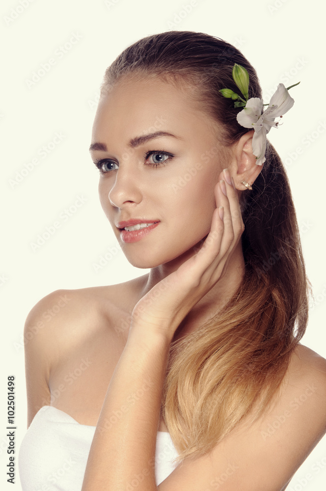 Close-up portrait of woman in three quarters a white lily in her Close-up portrait of woman in three quarters a white lily in her