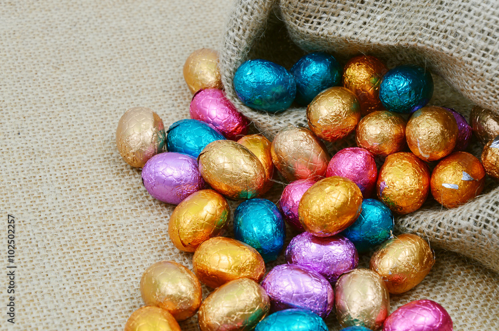 colorful egg chocolate on sack background colorful egg chocolate on sack background