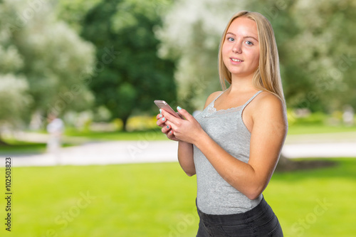 Teen girl texting on smart phone