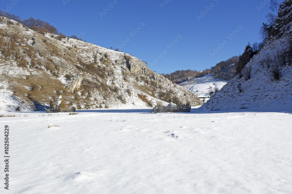 Frozen sunny day of a winter, on wild transylvania hills. Fundatura Ponorului. Romania. Low key, dark background, spot lighting, and rich Old Masters