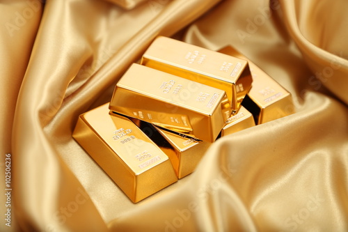 Gold bullion  isolated on gold cloth