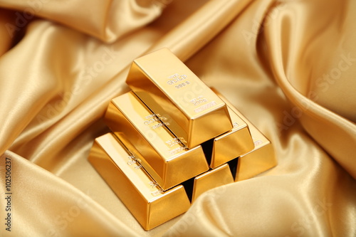 Gold bullion  isolated on gold cloth