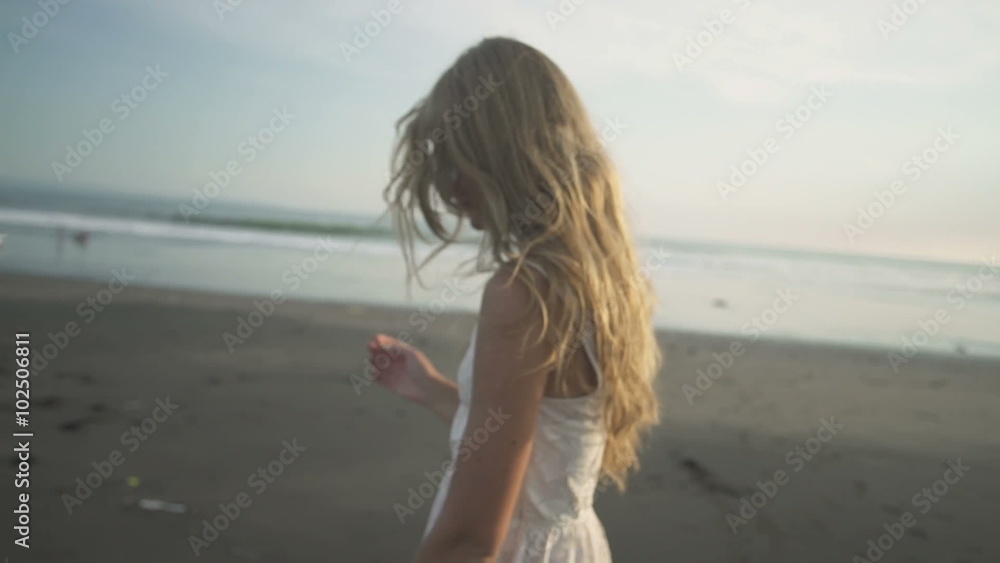 carefree woman dancing in the sunset on the beach carefree woman dancing in the sunset on the beach