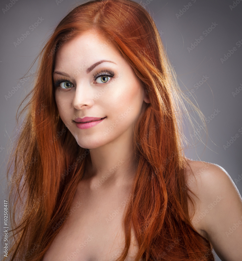 Fototapeta premium Beautiful young red-haired girl