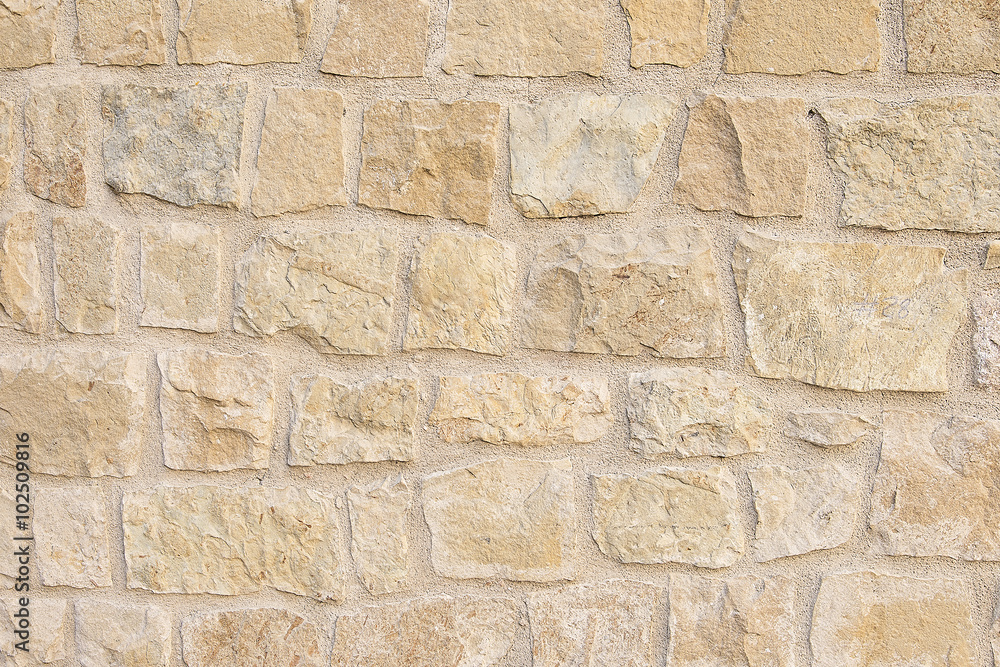 Fototapeta premium Old beige stone wall background texture