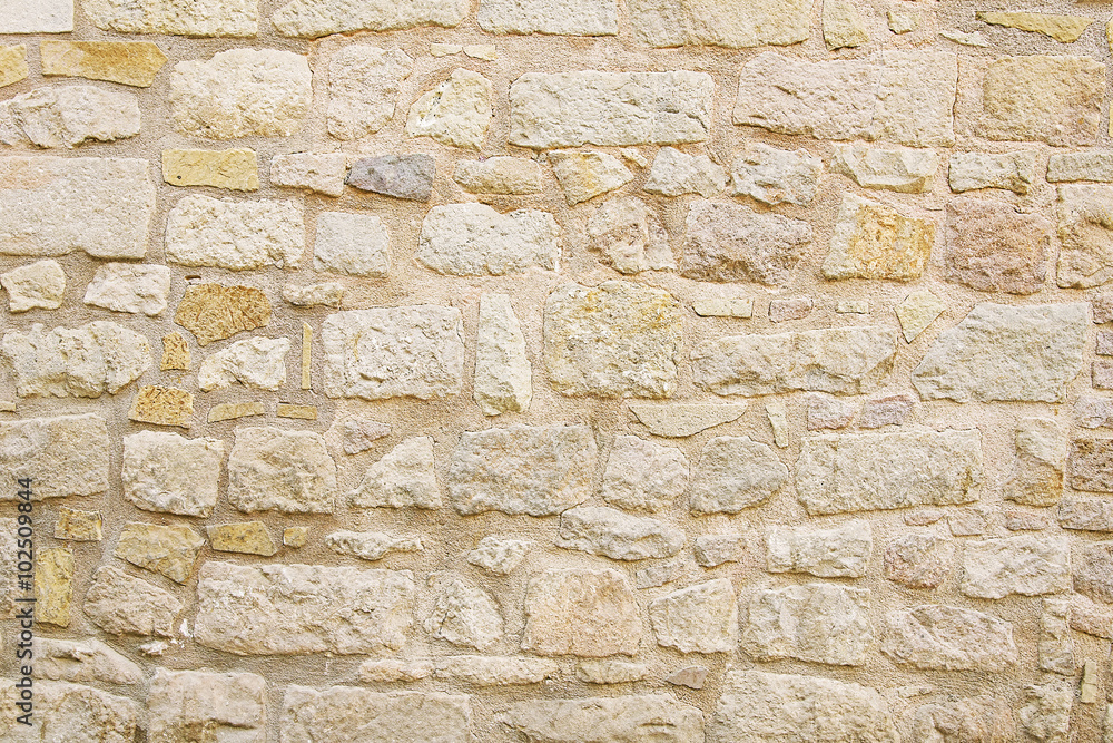 Fototapeta premium Old beige stone wall background texture