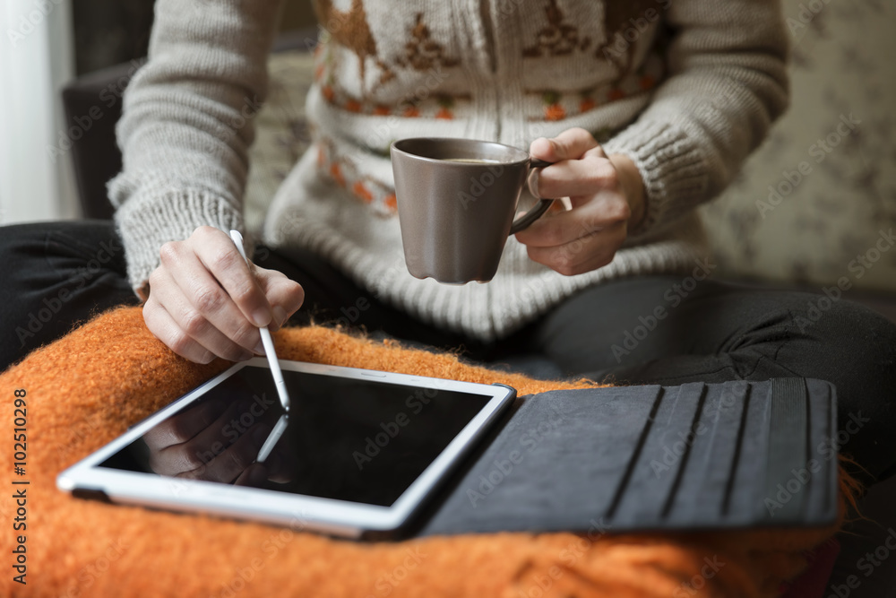 Woman Using Digital Tablet And Drinking Coffee At Home 