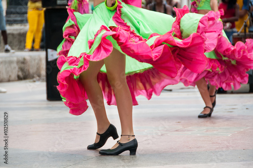girl dancing old dances with green and orange dress