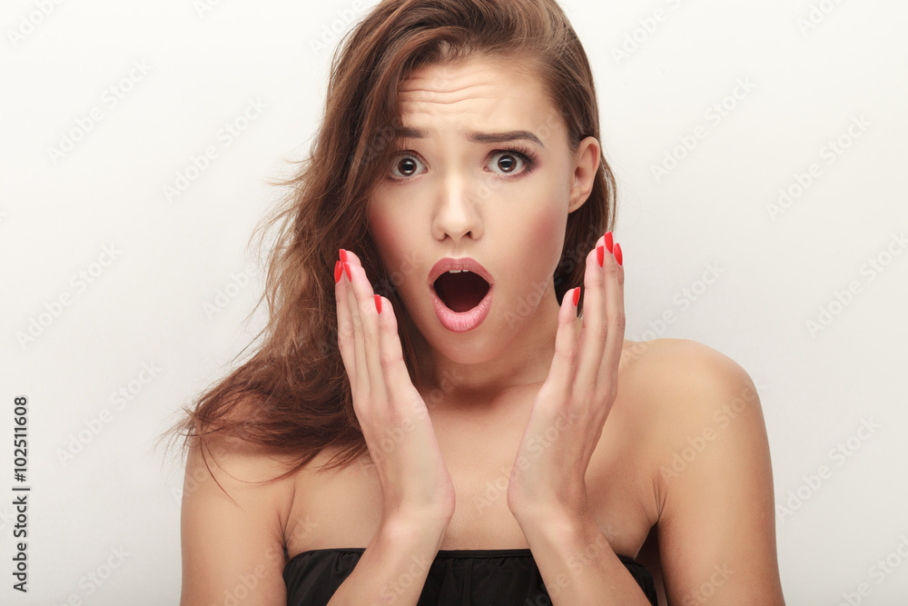 Closeup portrait of adorable surprised brunette woman in black bra posing on white studio background Closeup portrait of adorable surprised brunette woman in black bra posing on white studio background