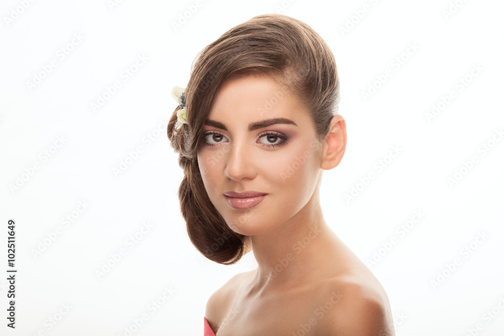 Closeup beauty portrait of cute young brunette woman with trendy adorable makeup low bun hairstyle flower headpiece on white background Closeup beauty portrait of cute young brunette woman with trendy adorable makeup low bun hairstyle flower headpiece on white background