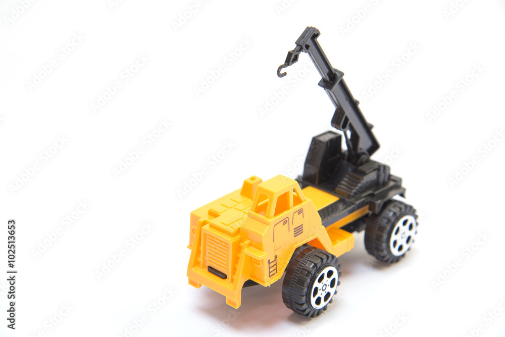Yellow toy crane, white background. Yellow toy crane, white background.