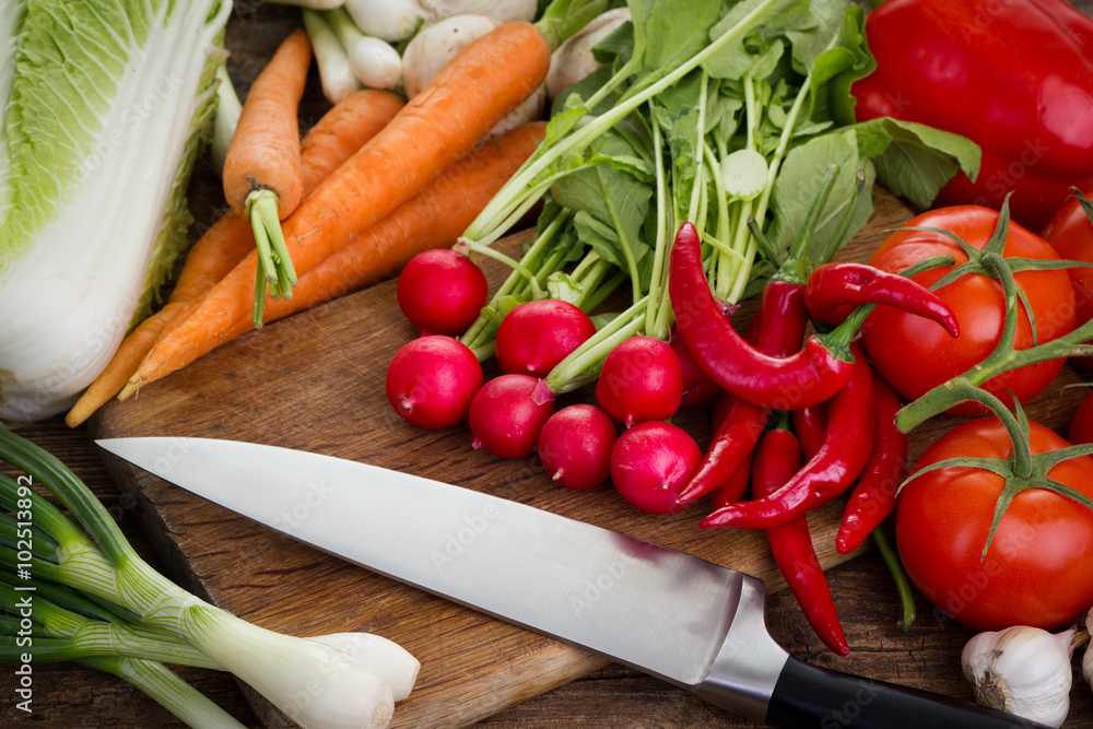 Fresh vegetables on kitchen board with knife Fresh vegetables on kitchen board with knife