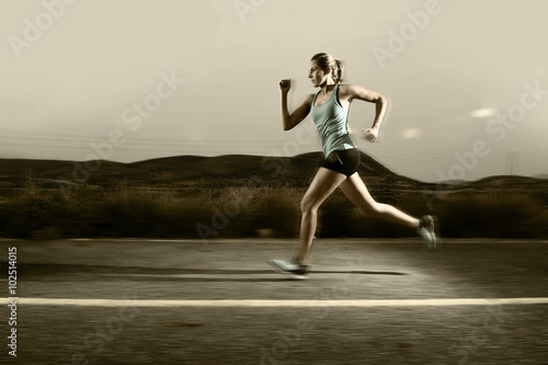 young fit sport woman running outdoors on asphalt road in mountain landscape background fitness and healthy lifestyle