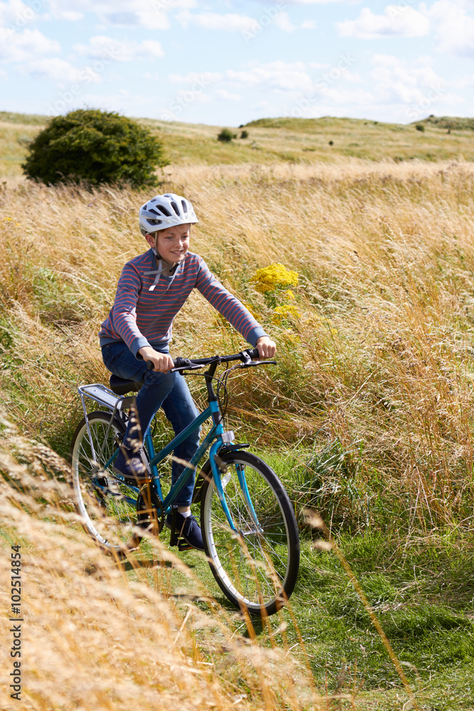 Boy Riding Bike Through Countryside
