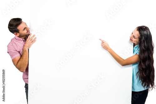 Young happy couple holding white sheet