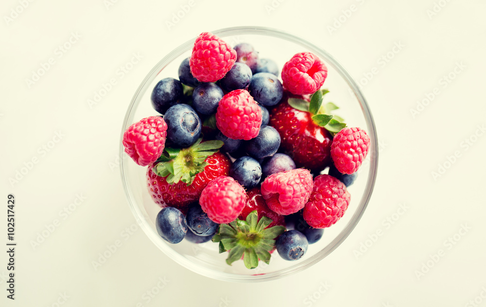 close up of summer berries in glass bowl close up of summer berries in glass bowl