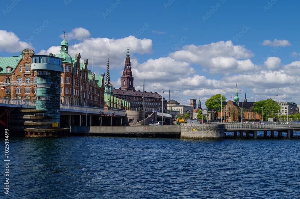 Copenhagen cityscape of canal and houses on embankment in sunny