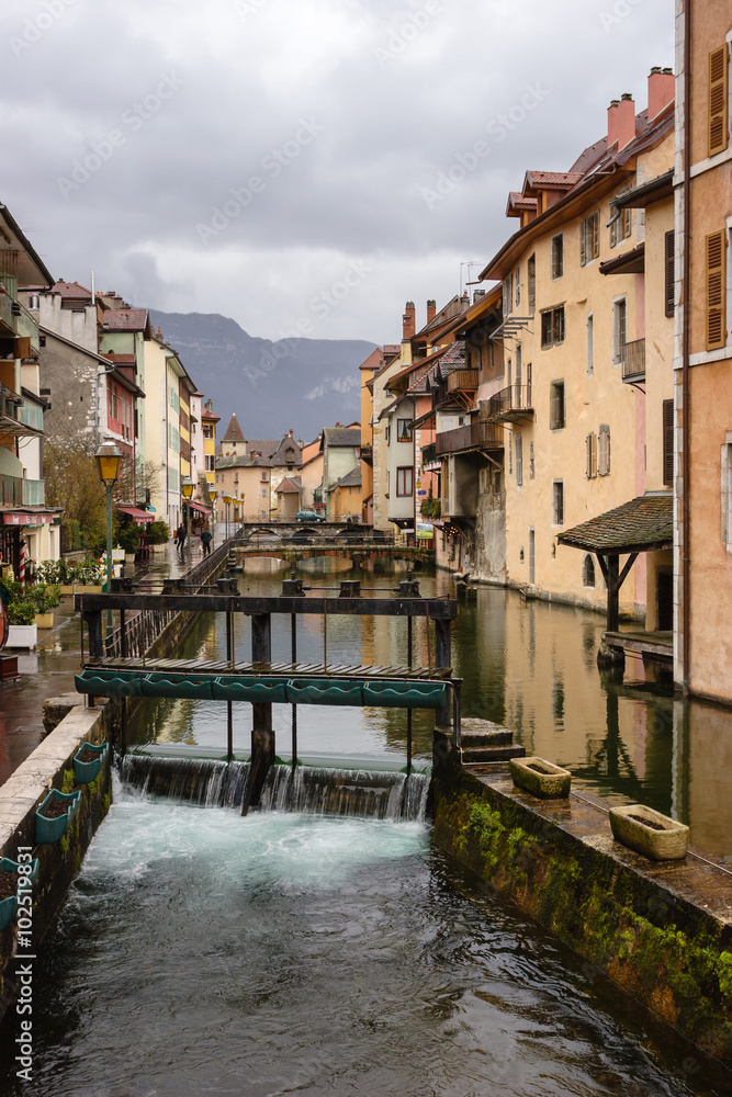 Canal with sluice gate at medieval town of Annecy France