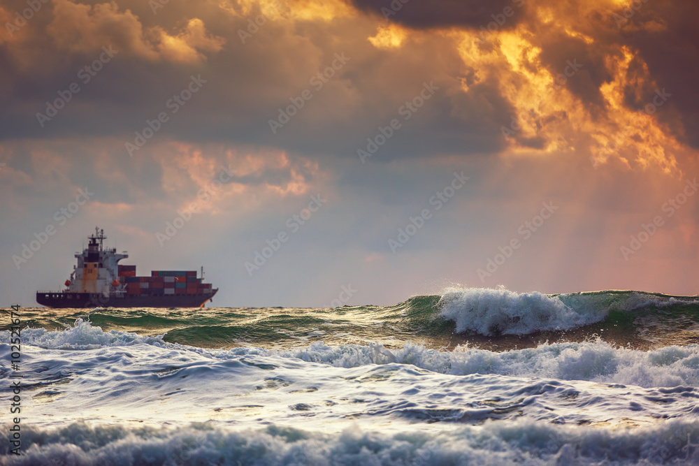Cargo ship with containers in sunrise light