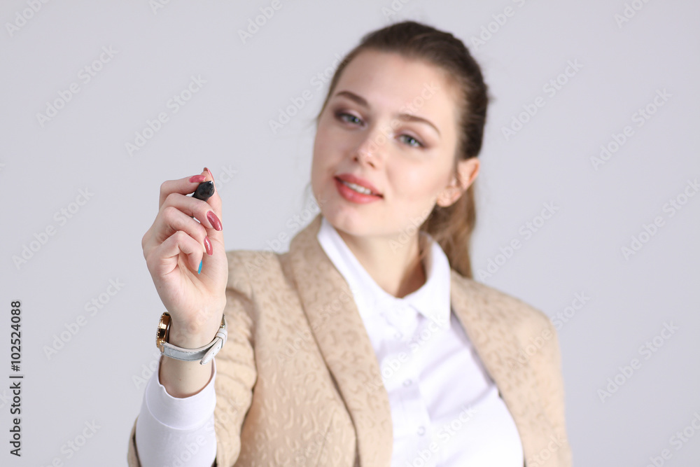 young woman with pen on grey background young woman with pen on grey background