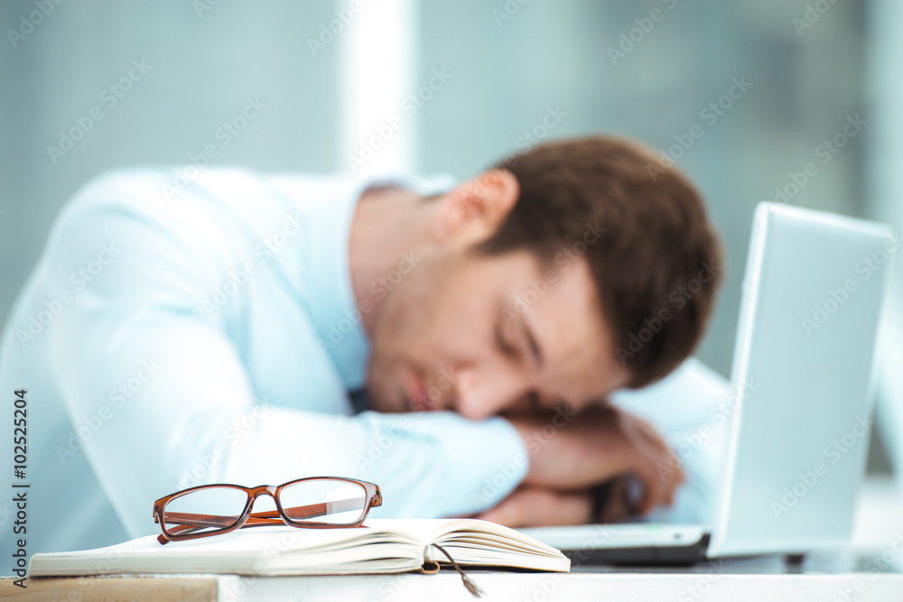 Young businessman in office with big window Young businessman in office with big window
