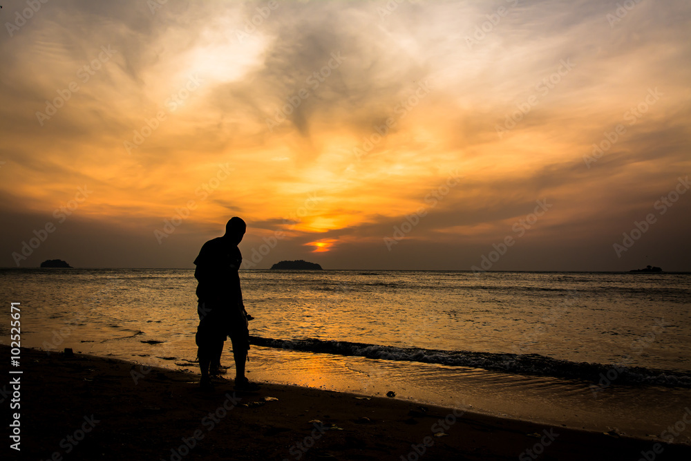 Silhouette people walking on the beach