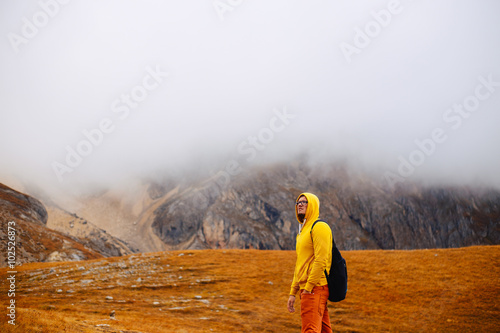 hiker man with backpack in mountains