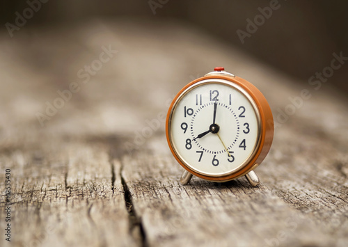 Retro alarm clock on a wooden table