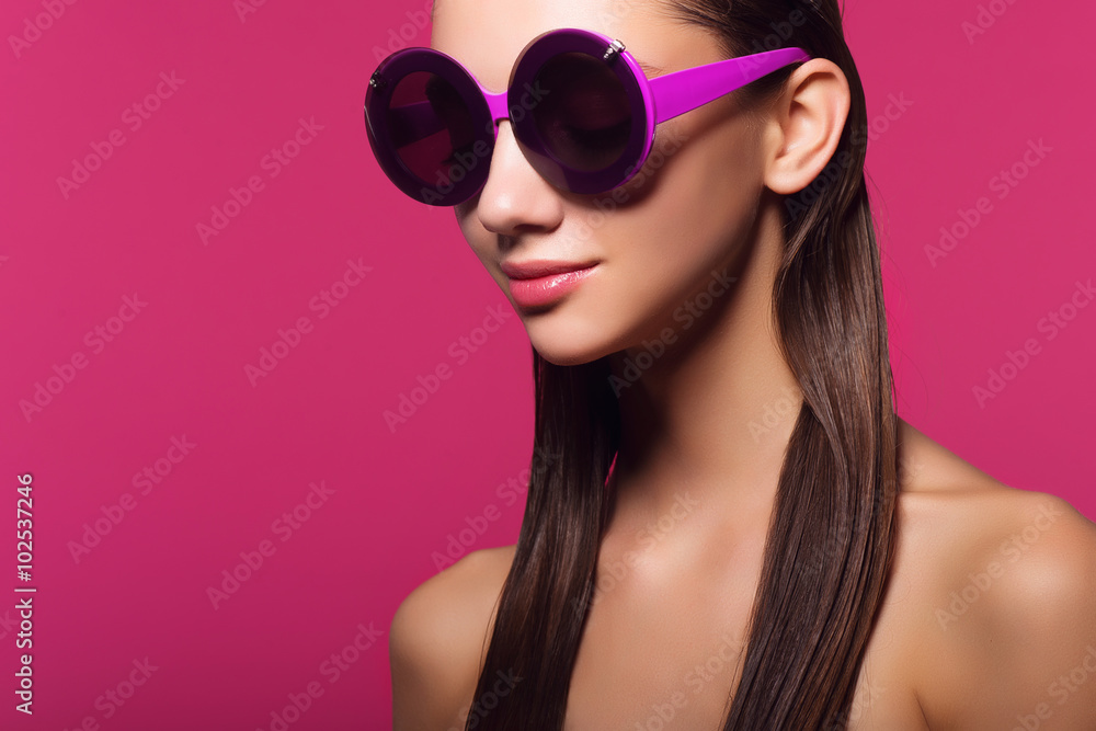 Portrait of a beautiful girl on a pink background in studio Portrait of a beautiful girl on a pink background in studio
