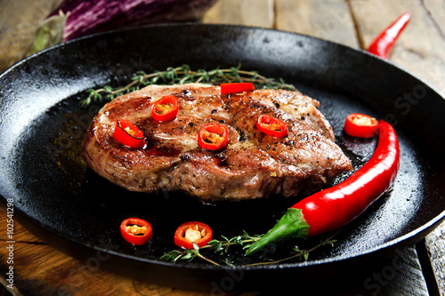 Cooking a steak in a frying pan