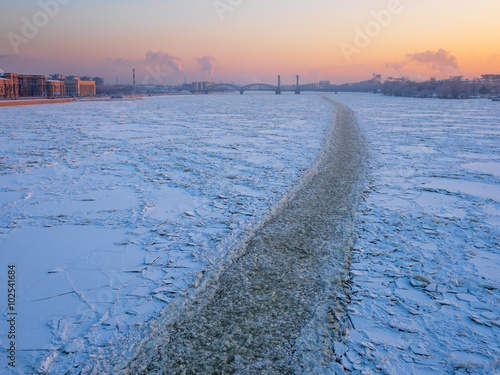 St. Petersburg in the winter. Frozen Neva River from the bridge of Alexander Nevsky in frosty sunset