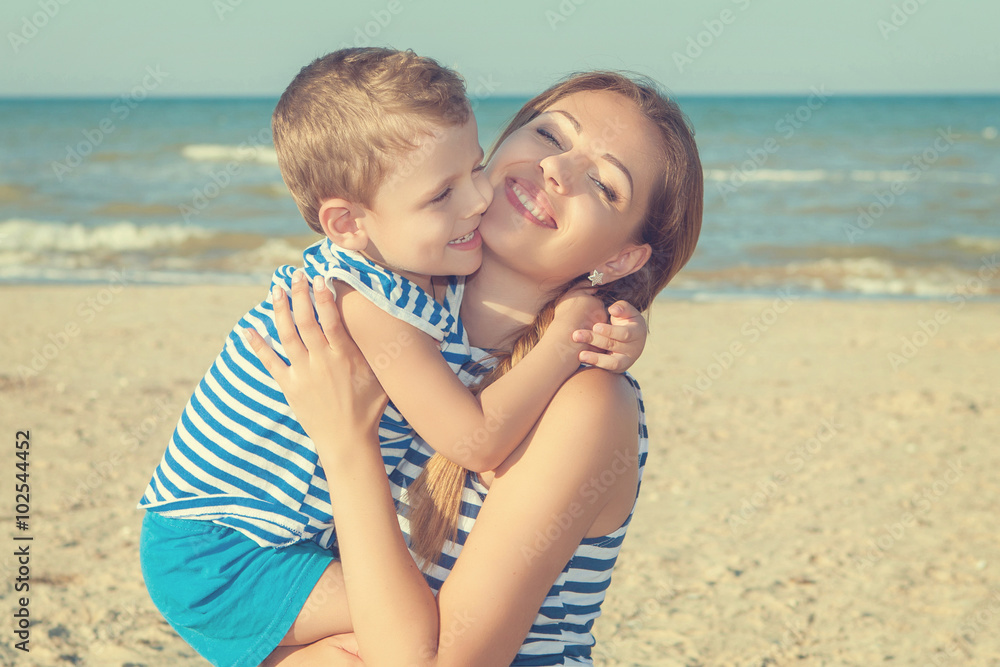 Mother and her son having fun on the beach