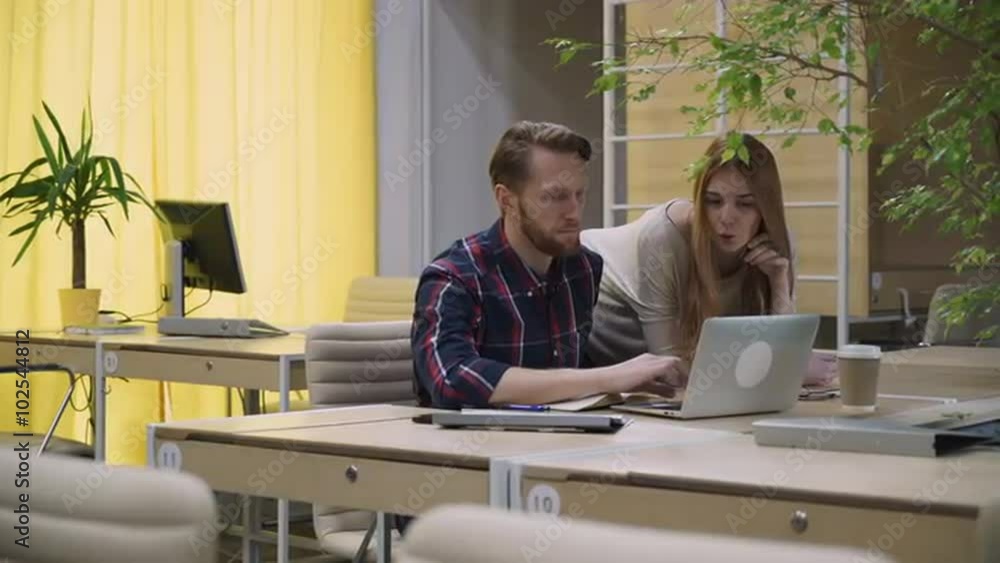 The guy with the girl talk looking at the computer The guy with the girl talk looking at the computer