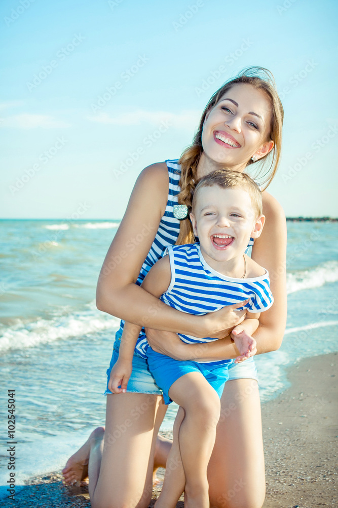 Mother and her son having fun on the beach Mother and her son having fun on the beach
