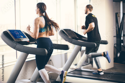 Couple running on treadmill