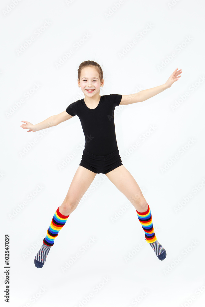 Slim teen girl doing gymnastics dance in jumping on white backgr Stock  Photo | Adobe Stock