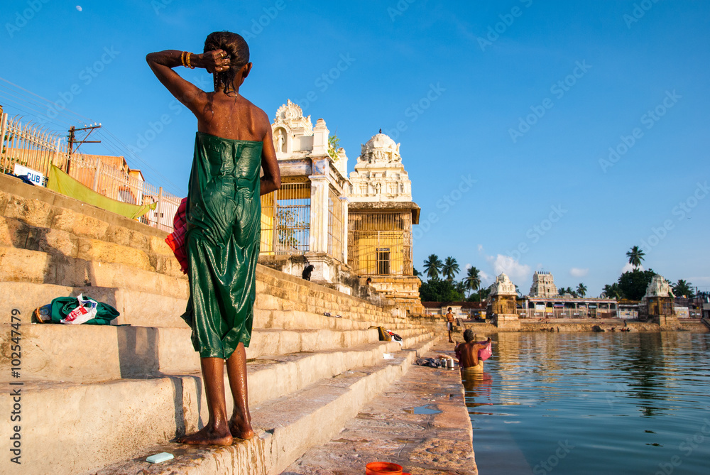 Indian  woman bathes in the sacred lake Mahamaham.in the town of Kumbakonam,Tamil Nadu, India