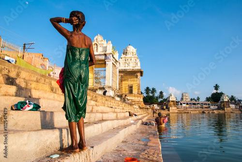 Indian  woman bathes in the sacred lake Mahamaham.in the town of Kumbakonam,Tamil Nadu, India © shafali2883