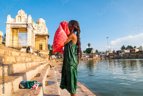 Indian woman bathes in the sacred lake Mahamaham.in the town of Kumbakonam, Tamil Nadu, India © shafali2883